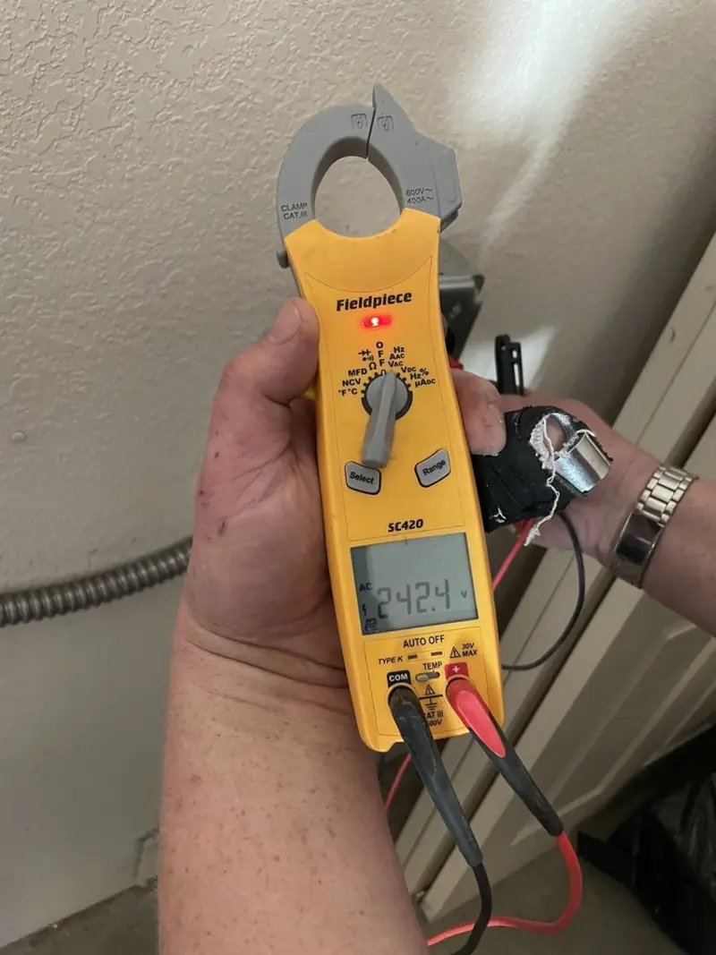 Voltage testing with clamp meter during Ceiling Fan Installation in Redland